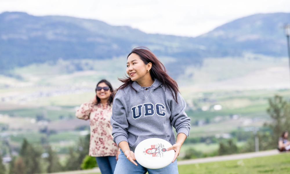 Students playing frisbee outside at UBC Okanagan