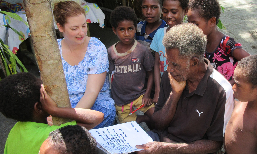 Dr. Christine Schreyer works with community members during a research project abroad.